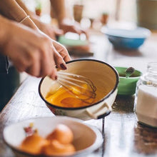 Handheld wire whisk for kitchen use, versatile for various tasks.