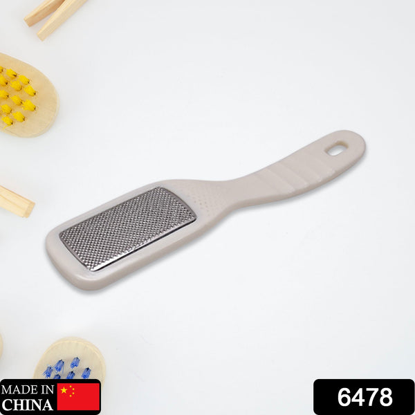 Foot corn remover with ergonomic handle.