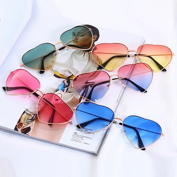 Heart-shaped sunglasses with multi-color reflective lenses.