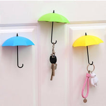 Set of 3 colorful umbrella-shaped wall hooks for organizing keys and small items.