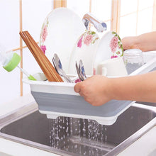 Silicone dish rack with utensil storage, folds for easy storage.